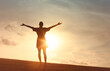 © kieferpix - Woman with outstretched arms enjoying the wind and breathing fresh air facing the sunrise, hope concept