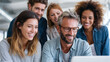 © Downloads - Smiling diverse group of people working together on laptop in modern office, showing teamwork and positive collaboration atmosphere