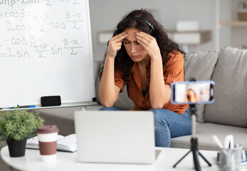 Aufkleber - Fatigue From Work. Tired young woman in headset feeling headache or stress, touching and massaging her forehead and temples, having video lesson with students, sitting at desk recording video