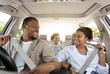 © Prostock-studio - Joyful Black Family Riding New Car Enjoying Summer Road Trip Together. Parents And Little Daughter Sitting In Automobile, Putting On Seat Belts For Safety. Transportation, New Auto Concept