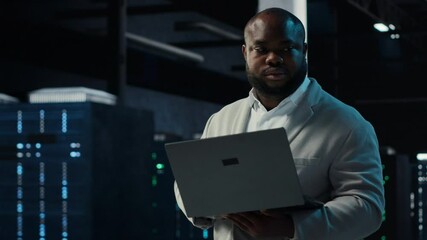 Poster - Data center IT expert reviewing performance dashboards of equipment rigs. Server room manager overseeing systems, examining infrastructure algorithms on laptop screen, camera B