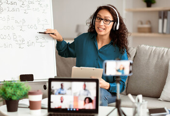 Aufkleber - Videoconference And Training. Class of diverse students learning remotely online using web app. Female teacher in headset providing lesson looking at pc screen, recording video on cellphone on tripod