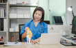 © M+Isolation+Photo - A middle-aged Asian female doctor at her desk,explaining various bone and joint diseases like arthritis,osteoporosis,and spinal disc degeneration,offering professional guidance in a clinical setting
