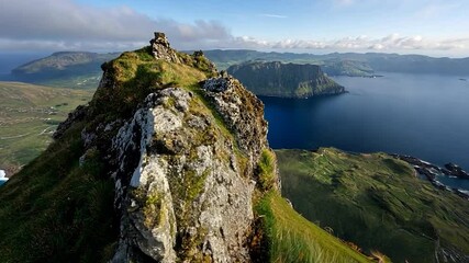 Poster - Aerial View of Rocky Mountain Overlooking Lake and Islands Under Cloudy Sky