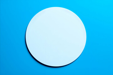 Poster - White Circle on Blue Background Top View Simple Geometric Composition. Mock up promotion information for marketing announcements and details, blank white space