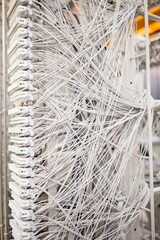 Poster - White telecom cables are intertwining chaotically on vertical patch panel in flat design artwork