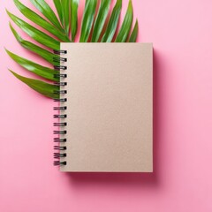 Poster - Eco-Friendly Spiral Notebook with Recycled Cardboard Cover on Pink Background and Green Leaf - Sustainable Stationery for Modern Green Living
