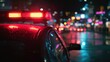 © sukarman - Close-Up of Police Car with Flashing Red Emergency Lights Parked on City Street at Night