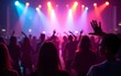 © fu - Crowd dancing under colorful lights at a lively party or concert. High quality