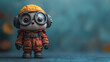 © Its - Astronaut toy in orange spacesuit with goggles on blue background standing alone