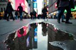 © Vera - Mirrored city skyscrapers glisten in water puddle on busy sidewalk.