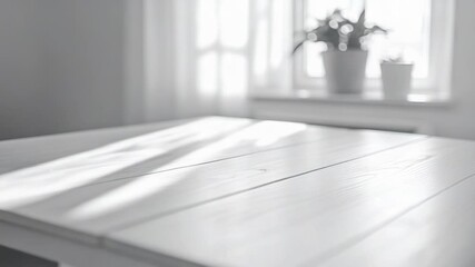 Poster - A minimalist interior scene with a white table and a potted plant placed in the window, ideal for decorating and design inspiration