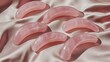 © Gisel - Pink quartz crescent-shaped massage tools on blush satin