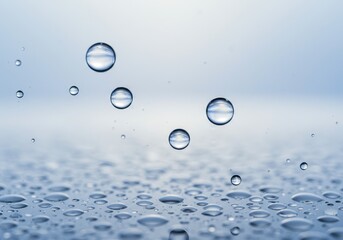 Poster - Water droplets on a surface with a light blue background, close up
