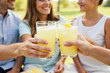 © Taniana Fomina - Friends toasting with lemonade glasses at outdoor picnic in summer