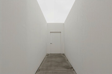 Poster - Narrow Concrete Walkway Leading to Minimalist White Door Built into Tall Clean Wall with No Texture