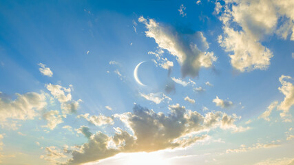 Wall Mural - young moon in the blue sky. moon at sunset between clouds. colorful astronomical landscape.