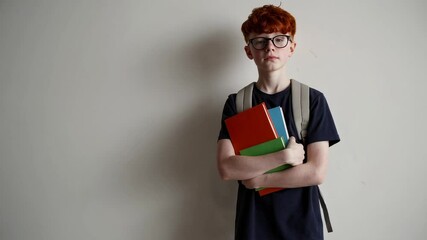 Aufkleber - Redhead student with glasses wearing backpack, holding colorful books and shifting facial expressions, representing academic learning and concentrated knowledge against white background