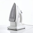 © Sultonah - Modern electric iron appliance for garment care stands ready for pressing on white background