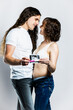 © Ametz - Young couple embracing and sharing pregnancy ultrasound and test. Lifestyle.