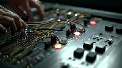 Poster - Close up view of a complex electronic control panel featuring illuminated buttons, intricate wiring, and various components, suggesting advanced technology and industrial automation