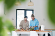 © SHOTPRIME STUDIO - Middle aged woman and older woman preparing healthy vegetables in a bright kitchen promoting active wellness and wellbeing for longevity and fitness.
