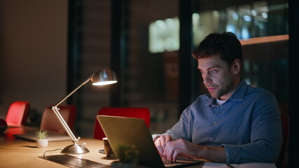 Poster - Late worker closing laptop tired of overtime work in night office closeup. 