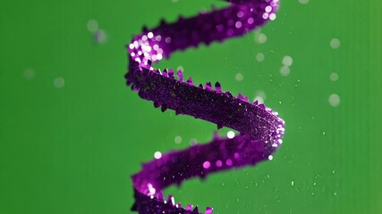 Poster - Iridescent purple spiral adorned with glittering particles rotating gracefully against green screen background, creating mesmerizing visual movement with dynamic floating elements