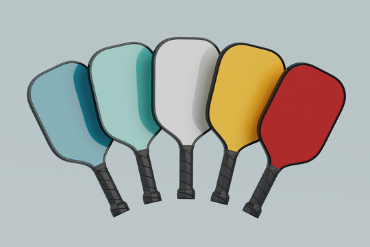 Modern Sports Equipment Concept. Set Of Five Colorful Pickleball Paddles. 3d Rendering