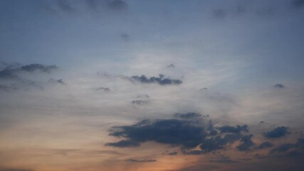 Wall Mural - A sunset sky timelapse with vibrant pink and orange clouds swirling across the horizon, fading gently into soft purples and blues, creating a warm and tranquil evening scene full of color. Time lapse.