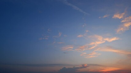 Wall Mural - a breathtaking sunset sky timelapse with rich hues of deep blue fading into warm oranges and pink cl