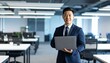 © 순단 강 - A Korean man in a suit holding a laptop computer to the right, with luxury office furniture in the blurred background