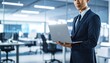 © 순단 강 - A Korean man in a suit holding a laptop computer to the right, with luxury office furniture in the blurred background