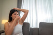 © Leo Lintang - Indonesian southeast asian woman feels uncomfortable because of the armpit odor at home. Healthcare concept
