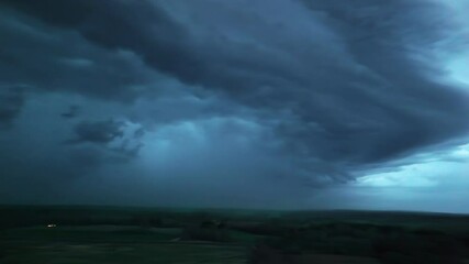 Wall Mural - panoramic view of thunderstorm sky over agricultural land, pov