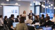 © VistaVisions - Business People Meeting and Working while Business Executive Lead Presenter Speaks to Group of Successful Technology Entrepreneurs. Consultant Advisor. Growth Training Lecture. Defocused Blurred