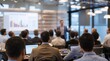 © VistaVisions - Business People Meeting and Working while Business Executive Lead Presenter Speaks to Group of Successful Technology Entrepreneurs. Consultant Advisor. Growth Training Lecture. Defocused Blurred