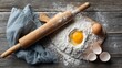 © Chingiz - Flat lay view of flour, egg yolk, and rolling pin on wooden board with room for text