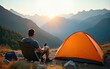 © wu - Man traveler relaxing in mountains near of tent camping gear outdoor Travel adventure lifestyle concept hiking active vacations. High quality