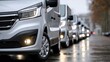 © Lightning - Silver vans lined up on a wet city street on a rainy day