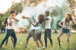 © oneinchpunch - Group of teens playing with colors at the holi festival, in a park