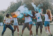 © oneinchpunch - Group of teens playing with colors at the holi festival, in a park
