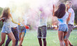 © oneinchpunch - Group of teens playing with colors at the holi festival, in a park