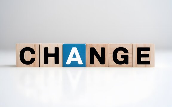 Word change spelled out with wooden letter blocks representing transformation and innovation