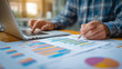 © Dhananjoy - Financial Analyst Working on Data Report with Charts and Graphs