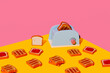 © VISTA by Westend61 - Blue toy toaster and toasted bread against colorful background