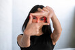 © VISTA by Westend61 - Young woman wearing AR glasses framing with hands indoors