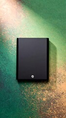 Poster - Elegant flat lay of external hard drive on textured green background with vibrant shades