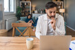 © Srdjan - Finance and economy. Young man, small business owner, working online at home office, preparing for video call for presentation and online coaching. E-commerce professional occupation freelance work