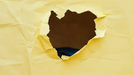 Aufkleber - A black cat peeks out from a hole in a bright yellow paper